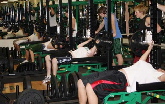 A row of individuals doing Bench Press Weightlifting