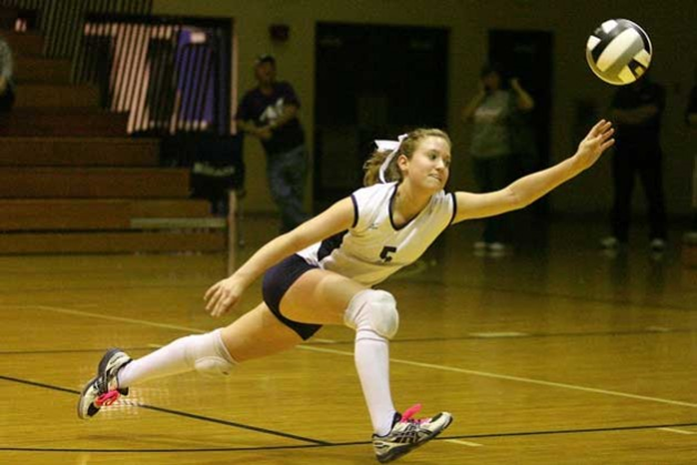Volleyball player reaching for volleyball
